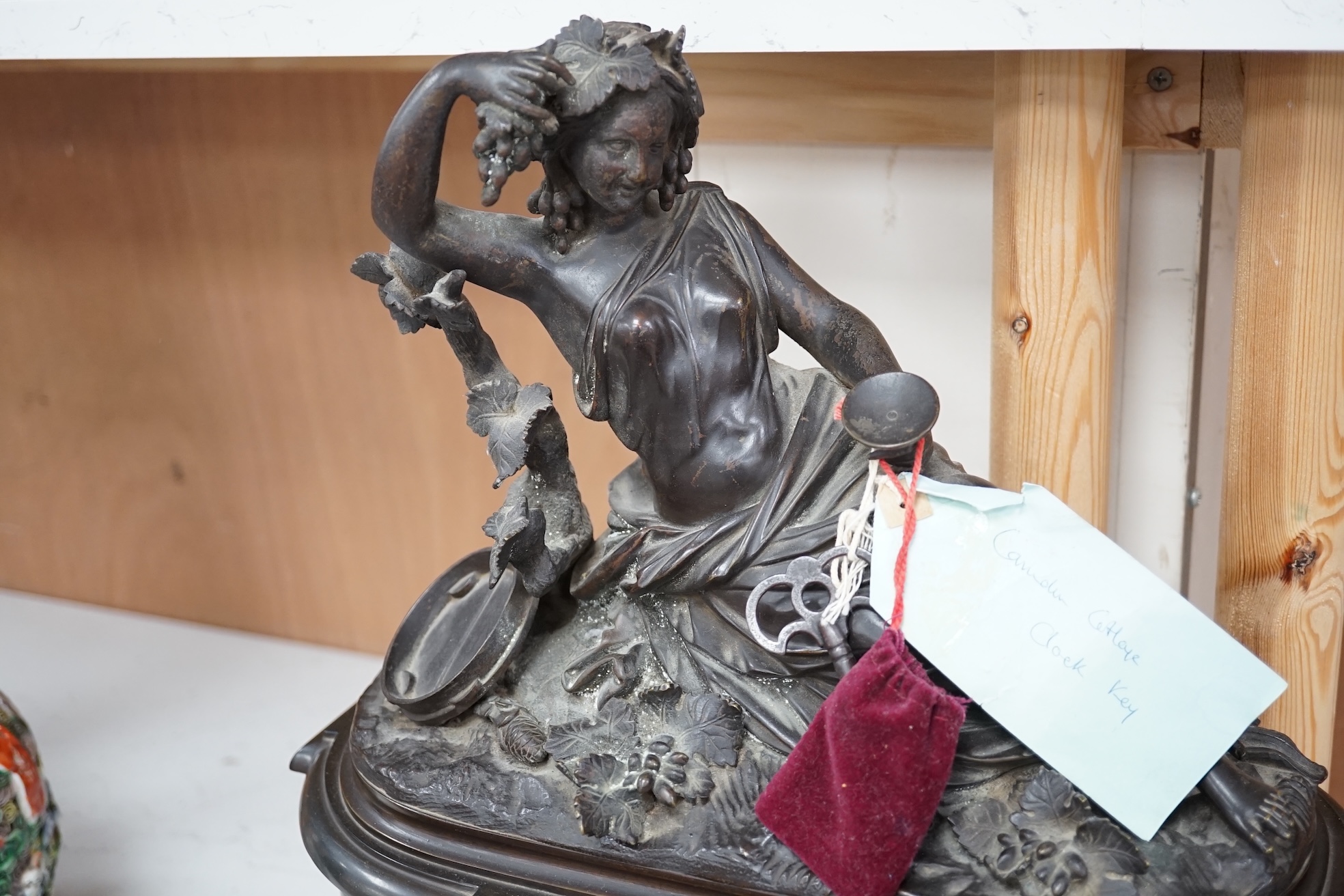 A Victorian black marble eight day mantel clock, surmounted by a cast bronze figure of a muse, with key, 48cm high. Condition - fair, untested